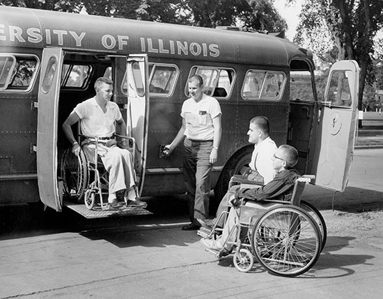 1955 photo of guys using wheelchair lift on a bus