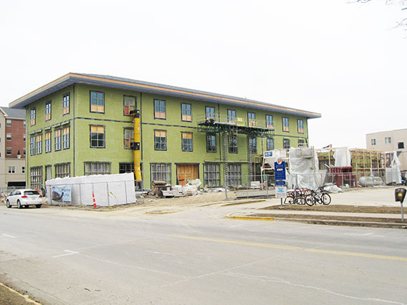 Construction site, February 17, 2015. 1st floor windows filling in with glass.