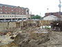 Construction site, June 10, 2014. 2 concrete walls of foundation are in place.